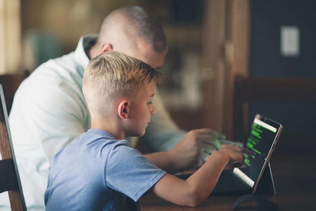Father teaching son to code