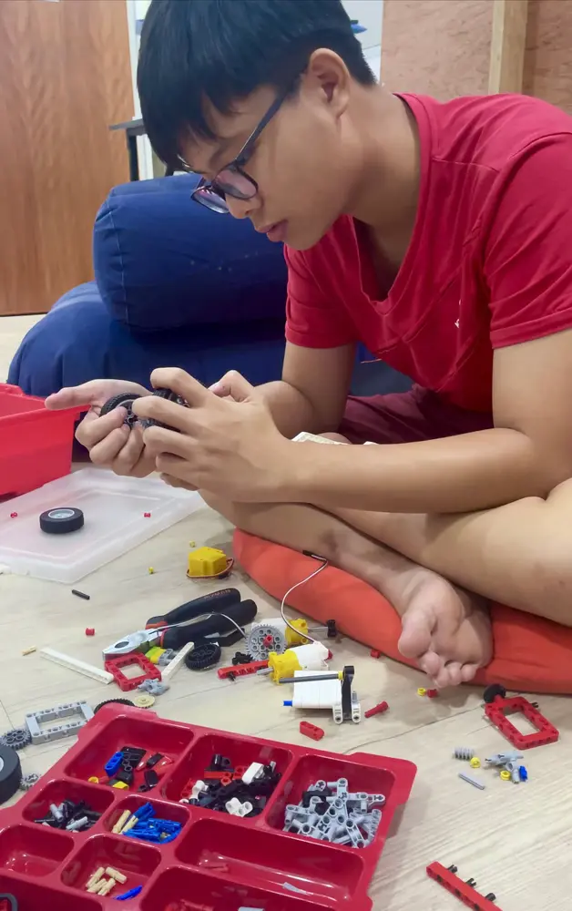 Student using lego to create scooter