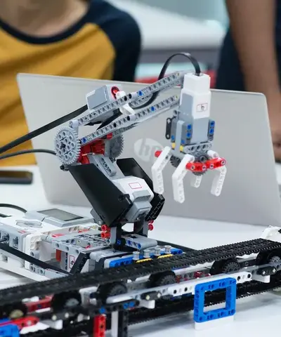 University Nottingham students using Lego robotics kit to build robot arm with conveying system