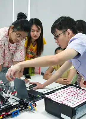 chemical engineering student using lego robotics kit to make industry AI machine